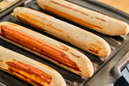 Cooking white german sausages on electric grill close up detailの写真素材