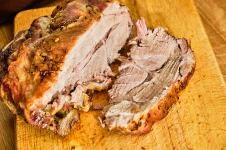 tasty roasted pork neck meat slice on wooden cutting boardの写真素材