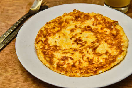 Tasty homemade omelette on white plate, serving and glass of lemonade on wooden tableの写真素材