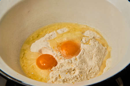 Preparing dough with eggs and flour in bowl for homemade pancakesの写真素材
