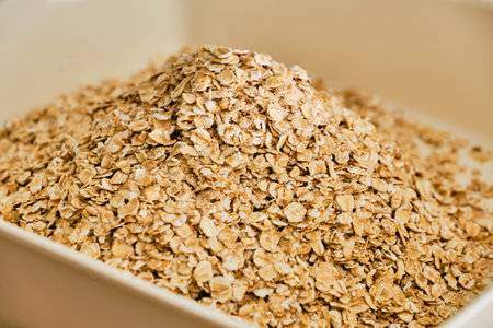 Raw oatmeal pile in white bowl