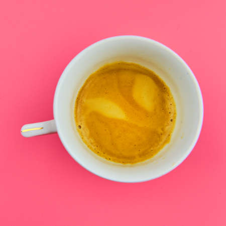 Cup of tasty espresso coffee on pink background top viewの写真素材