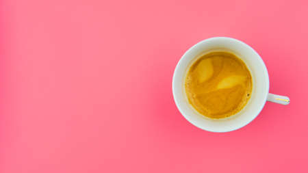 Cup of tasty espresso coffee on pink background with copy space top viewの写真素材