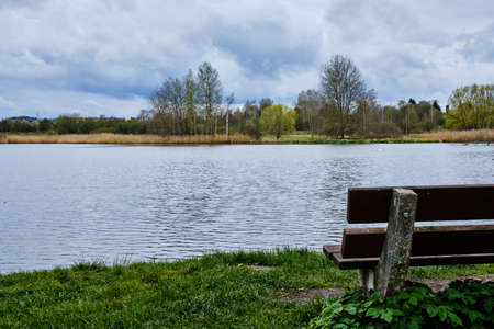 Pond Natalie with bench for relax in spa town Frantiskovy Lazne in Springの写真素材