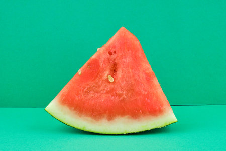 Tasty fresh red watermelon on green backgroundの写真素材