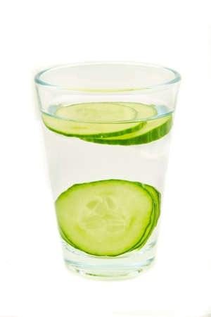 Fresh water with sliced cucumber isolated on white backgroundの写真素材