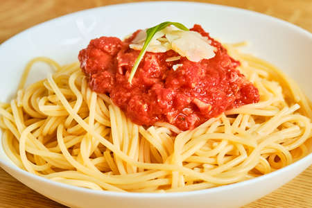 Tasty spaghetti with tomato sauce and cheese in bowlの写真素材