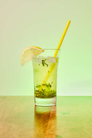 Refreshing lemon and mint lemonade in glass with iceの写真素材