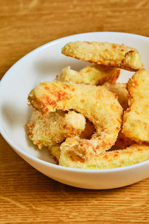 Tasty breaded pattypan squash in white bowlの写真素材