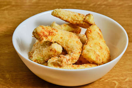 Tasty breaded pattypan squash in white bowlの写真素材