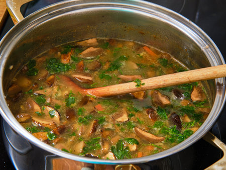 Preparing homemade mushroom soup in cooking potの写真素材