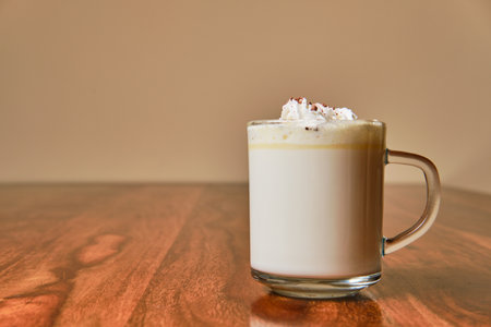 Tasty hot white chocolate with cream in glass cupの写真素材