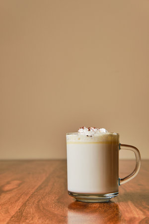 Tasty hot white chocolate with cream in glass cupの写真素材