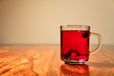 Red hot tea with forest fruit in glass cupの写真素材