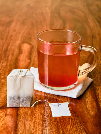 Hot fruit tea in glass and teabagの写真素材