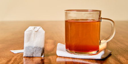 Hot fruit tea in glass and teabagの写真素材