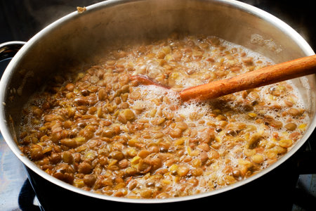 Preparing tasty lentil food in cooking potの写真素材
