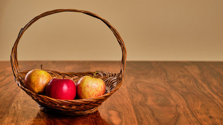 Tasty fresh apples in basket with copy spaceの写真素材