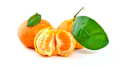 Tangerine fruit with green leaves isolated on white backgroundの写真素材