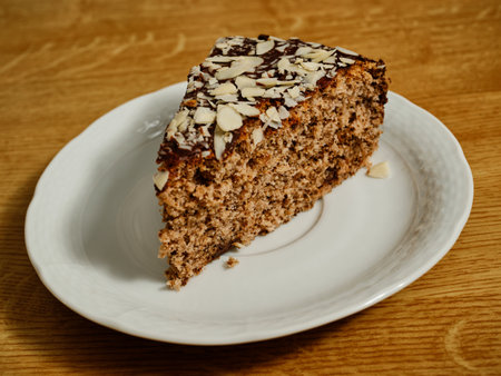 Tasty walnut cake with chocolate and almond toppingの写真素材
