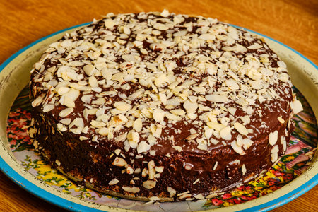 Whole tasty walnut cake with almond and chocolate toppingの写真素材
