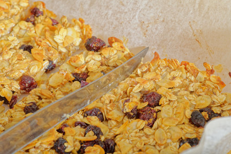 Cutting sugar free oatmeal bar on baking paperの写真素材