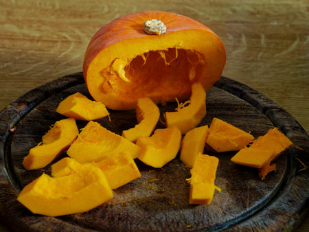 Sliced Hokkaido pumpkin on cutting board close upの写真素材