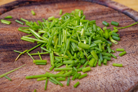Fresh chopped green chives on cutting boardの写真素材