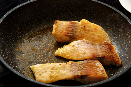 Cooking tasty carp fish steak on frying panの写真素材