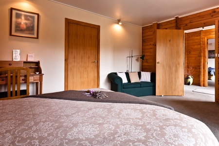 Nice warm bedroom interior of mountain lodge. Fox Glacier Lodge, Fox Glacier, West Coast, South Island, New Zealand.の写真素材