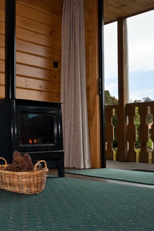 Detail of fireplace. Nice warm interior of mountain lodge apartment. Fox Glacier Lodge, Fox Glacier, West Coast, South Island, New Zealand.の写真素材