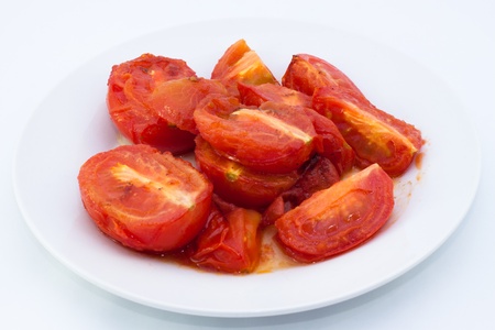Roasted tomatoes on plate with white background.の写真素材