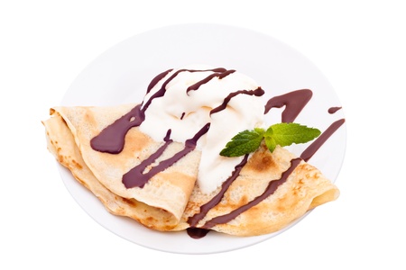 Crepe with ice cream and chocolate topping, isolated on white background. A crepe is a type of very thin pancake. It is very popular in France. Crepe may contain a variety of fillings. It can serve as main meal or a dessert.の写真素材