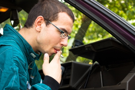 Young worker smoking in the car.の写真素材