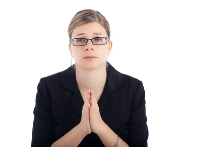 Desperate young woman praying, isolated on white background.の写真素材