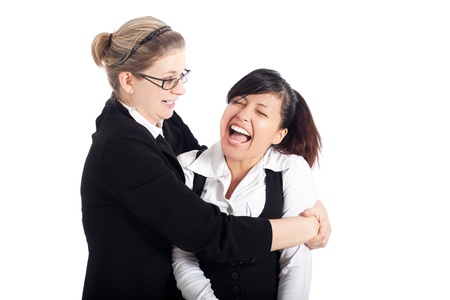 Two young happy business women funny moment, isolated on white background.の写真素材