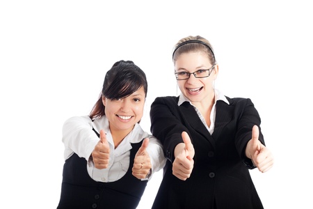Two young happy business women gesturing thumbs up, isolated on white background.の写真素材