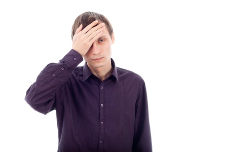 Portrait of man with headache, touching his head. Isolated on white background.の写真素材
