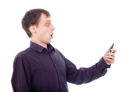 Funny surprised nerd man looking at cellphone, isolated on white background.の写真素材