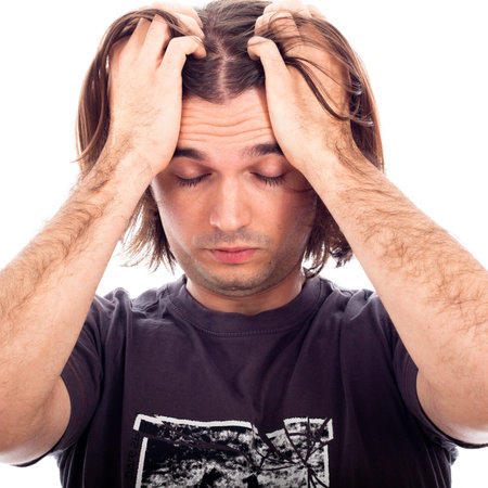 Portrait of tired man holding his head, isolated on white background.