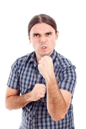 Angry aggressive young man, isolated on white background.の写真素材