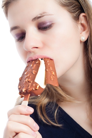 Young beautiful woman eating delicious ice cream, isolated on white background.の写真素材
