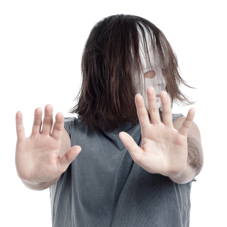 Horror scary masked man gesturing stop sign, isolated on white background.の写真素材