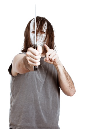 Horror scary masked menacing man with knife, isolated on white background.の写真素材