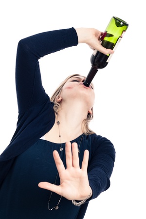 Portrait of young drunk woman drinking wine and gesturing stop, isolated on white background.の写真素材