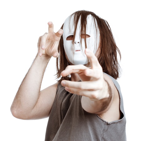 Insane scary masked man gesturing, isolated on white background.の写真素材
