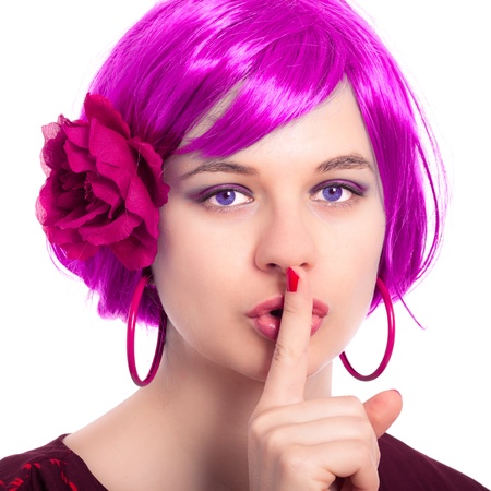 Portrait of beautiful woman in pink wig gesturing silence.の写真素材