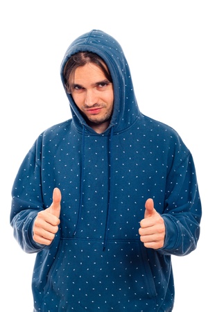 Portrait of young happy confident man in blue hoodie gesturing thumbs up, isolated on white background.の写真素材