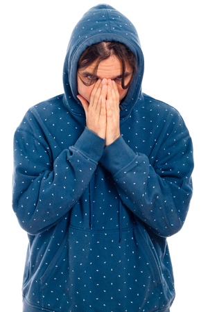 Portrait of young serious worried man in blue hoodie, isolated on white background.の写真素材
