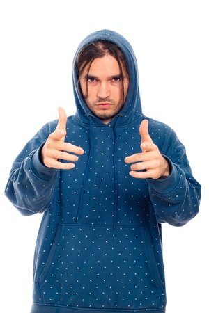 Portrait of young confident man in blue hoodie pointing, isolated on white background.の写真素材